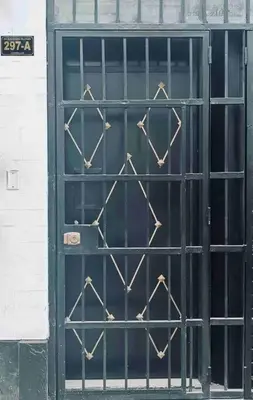 a black door with iron bars on a building at Mini Apartamento, cerca al Malecón de Chorrillos in Lima