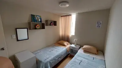 a bedroom with two twin beds and a window at Apartamento Varela 3 dormitorios in Lima