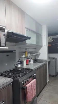 a kitchen with a stove with a pot on it at Apartamento Varela 3 dormitorios in Lima