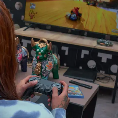 a person holding a video game controller in front of a tv at Way Kap Hostel Cusco in Cusco