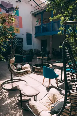 a group of chairs and tables in a courtyard at Way Kap Hostel Cusco in Cusco