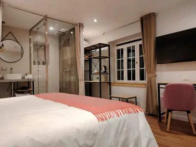 a bedroom with a large bed and a bathroom at Casa Cruz Verde by Peru Garden Hotels in Cusco