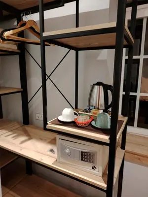 a bunk bed with a microwave on a shelf at Casa Cruz Verde by Peru Garden Hotels in Cusco