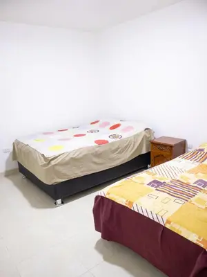 two beds sitting in a room with at Resort Maldo in Ayacucho