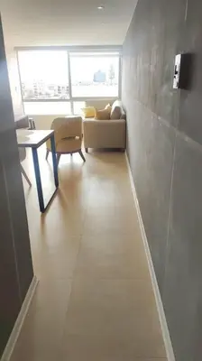 a room with a table and a couch and a table at Super céntrico y Hermoso Muy cerca a INEN in Lima