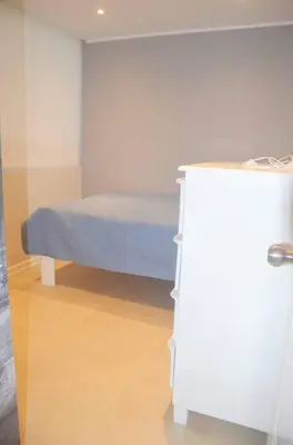 a hospital room with a bed and a table at Super céntrico y Hermoso Muy cerca a INEN in Lima