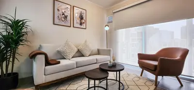 a living room with a couch and a chair at Departamento de Estreno en Miraflores in Lima