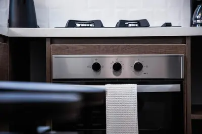 a stove top oven with a towel on it at Departamento de Estreno en Miraflores in Lima