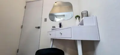 a white dressing table with a mirror next to a door at Departamento de Estreno en Miraflores in Lima