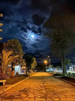 an empty street at night with the moon in the sky at Hospedaje Mónaco - Jauja Airport in Jauja