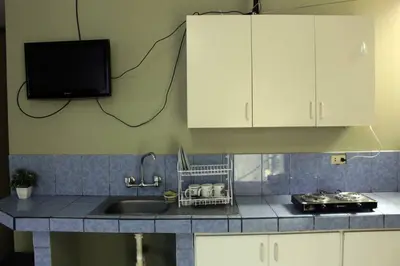 a kitchen with a sink and a tv on the wall at Departamento Completo en San Luis - Complete Apartment in San Luis in Lima