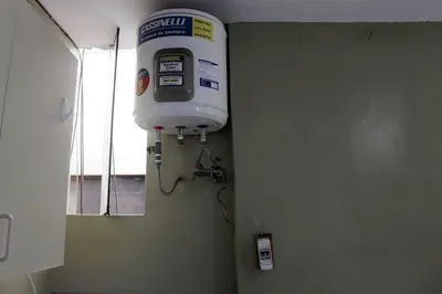 a water tank hanging from a wall in a bathroom at Departamento Completo en San Luis - Complete Apartment in San Luis in Lima