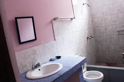 a bathroom with a sink and a toilet and a mirror at Departamento Completo en San Luis - Complete Apartment in San Luis in Lima