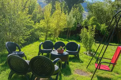 a group of chairs and a table in the grass at La Casita de Orfi in Calca