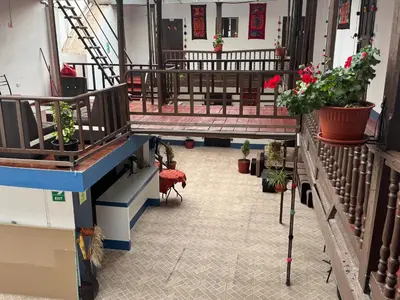 a hallway with potted plants and stairs in a building at Mallku Wasi - Lodging Hotel Cusco in Cusco