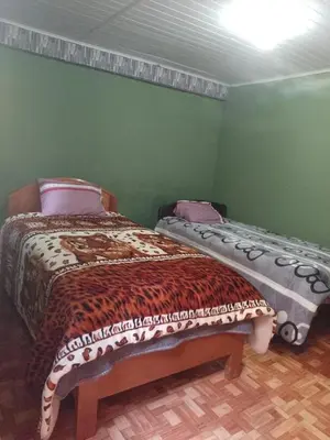 a bedroom with a bed and a bench in it at Lucmabamba Dulcesueños Xiomara in Sahuayacu