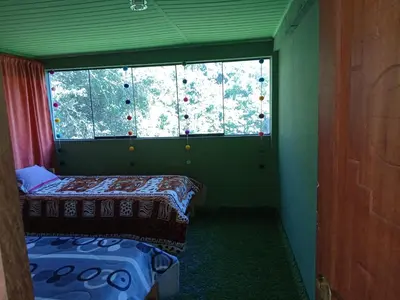 a small room with two beds and a window at Lucmabamba Dulcesueños Xiomara in Sahuayacu