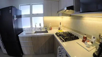 a kitchen with a sink and a stove top oven at Excelente ubicación, vista al mar, cerca a Costa 21 in Lima