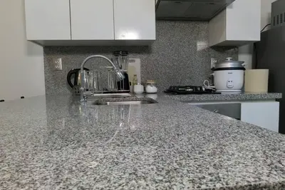 a kitchen with a sink and a counter top at Hermoso departamento con piscina, gimnasio, sala parrillas in Lima
