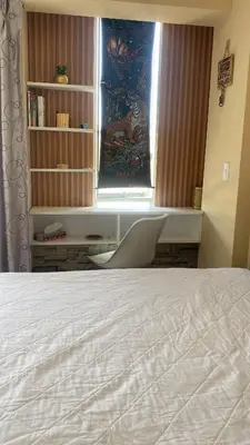 a bedroom with a bed and a window and a chair at Sai in Lima