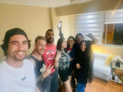 a group of people posing for a picture in a room at Sai in Lima