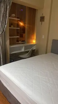 a bedroom with a white bed and a desk at Sai in Lima