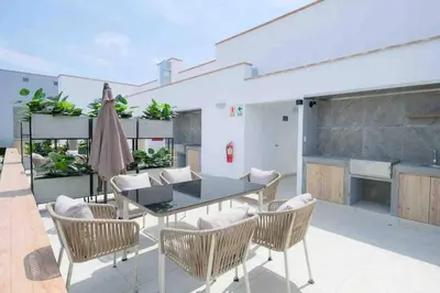 a patio with a table and chairs on a patio at Departamento estrenó céntrico a universidades in Lima
