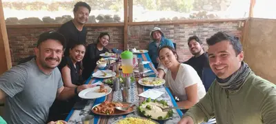 a group of people sitting around a table eating food at SORAYPAMPA - Cabañas Andinas Mamá Andrea Eco Lodge in Soray