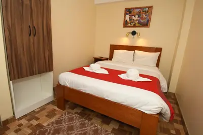 a bedroom with a bed with two towels on it at Casa Medina Hostal in Cusco