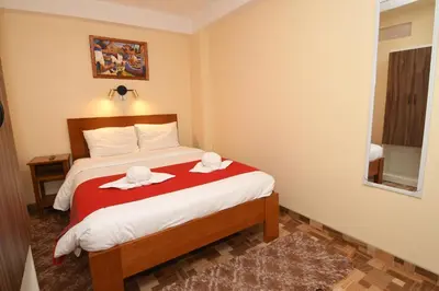 a bedroom with a bed with two hats on it at Casa Medina Hostal in Cusco