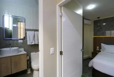 a bathroom with a bed and a toilet and a sink at Dasso 167 by Wynwood House in Lima