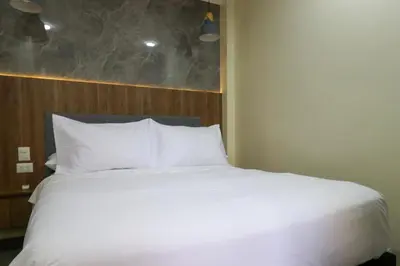 a bed in a room with a large white bed at Dasso 167 by Wynwood House in Lima
