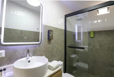 a bathroom with a sink and a shower at Dasso 167 by Wynwood House in Lima