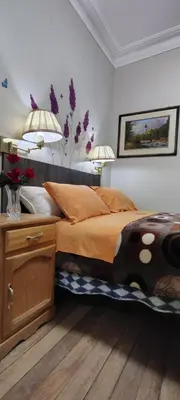 a bedroom with a large bed with two lamps at Hospedaje CASA REAL in Huancayo