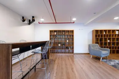 a room with chairs and a desk and shelves at Miraflores Centre Boutique Apartment 101B in Lima