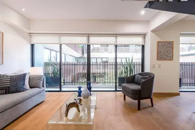 a living room with a couch and a chair at Miraflores Centre Boutique Apartment 101B in Lima