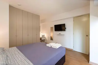 a bedroom with a bed and a tv on the wall at Miraflores Centre Boutique Apartment 101B in Lima