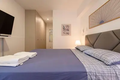 a bedroom with a blue bed with two pillows at Miraflores Centre Boutique Apartment 101B in Lima