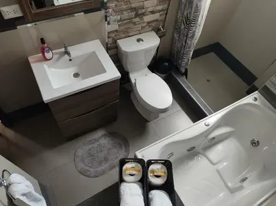 a bathroom with a tub and a toilet and a sink at Hathun House in Cusco