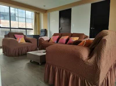 a living room with two couches and a table at Hathun House in Cusco