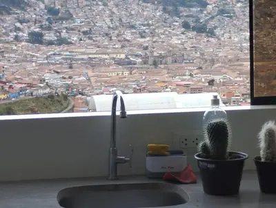a sink in front of a window with a cactus at Hathun House in Cusco