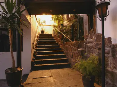 a stairway leading up to a building with potted plants at Hotel Montecristo Cusco in Cusco