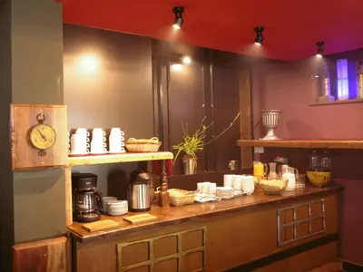 a kitchen with a counter with dishes on it at Hotel Montecristo Cusco in Cusco