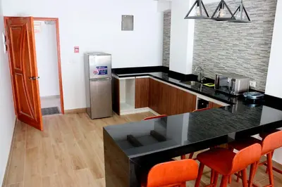a kitchen with a counter and a refrigerator at Ribera del Rio Club Resort in Cieneguilla