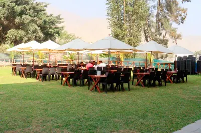 a group of tables and chairs under umbrellas at Ribera del Rio Club Resort in Cieneguilla