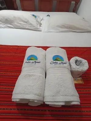 a pair of towels sitting on top of a bed at Hostal Cielo Azul in Canta