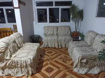 a living room with two couches and a table at Hostal Cielo Azul in Canta