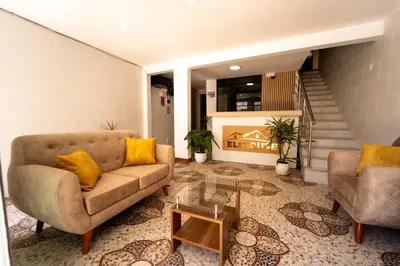 a living room with a couch and two chairs at Hotel Eli House in Nazca