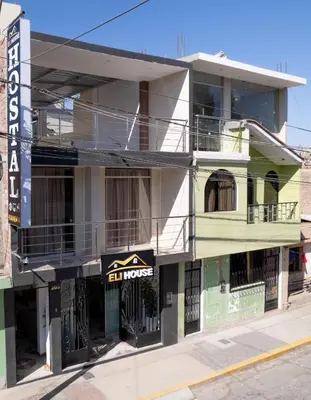 a building with a sign on the side of it at Hotel Eli House in Nazca