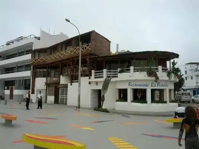 a building with people standing in front of it at Punta Hermosa in Punta Hermosa